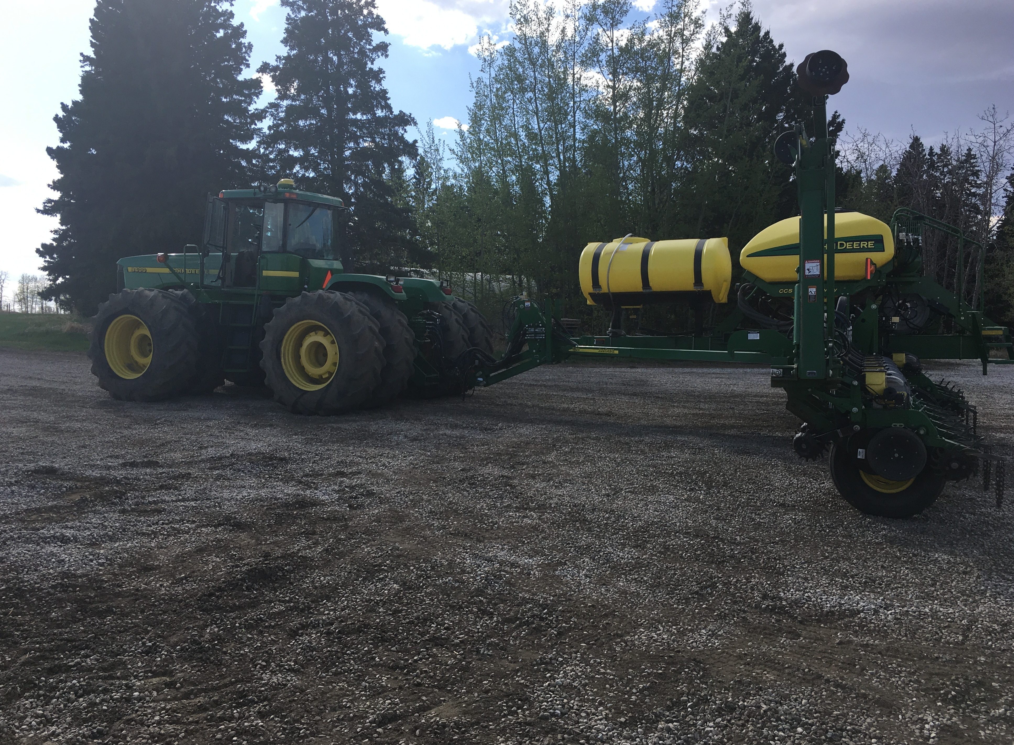 A four-wheel-drive tractor with an air seeder on a worked field